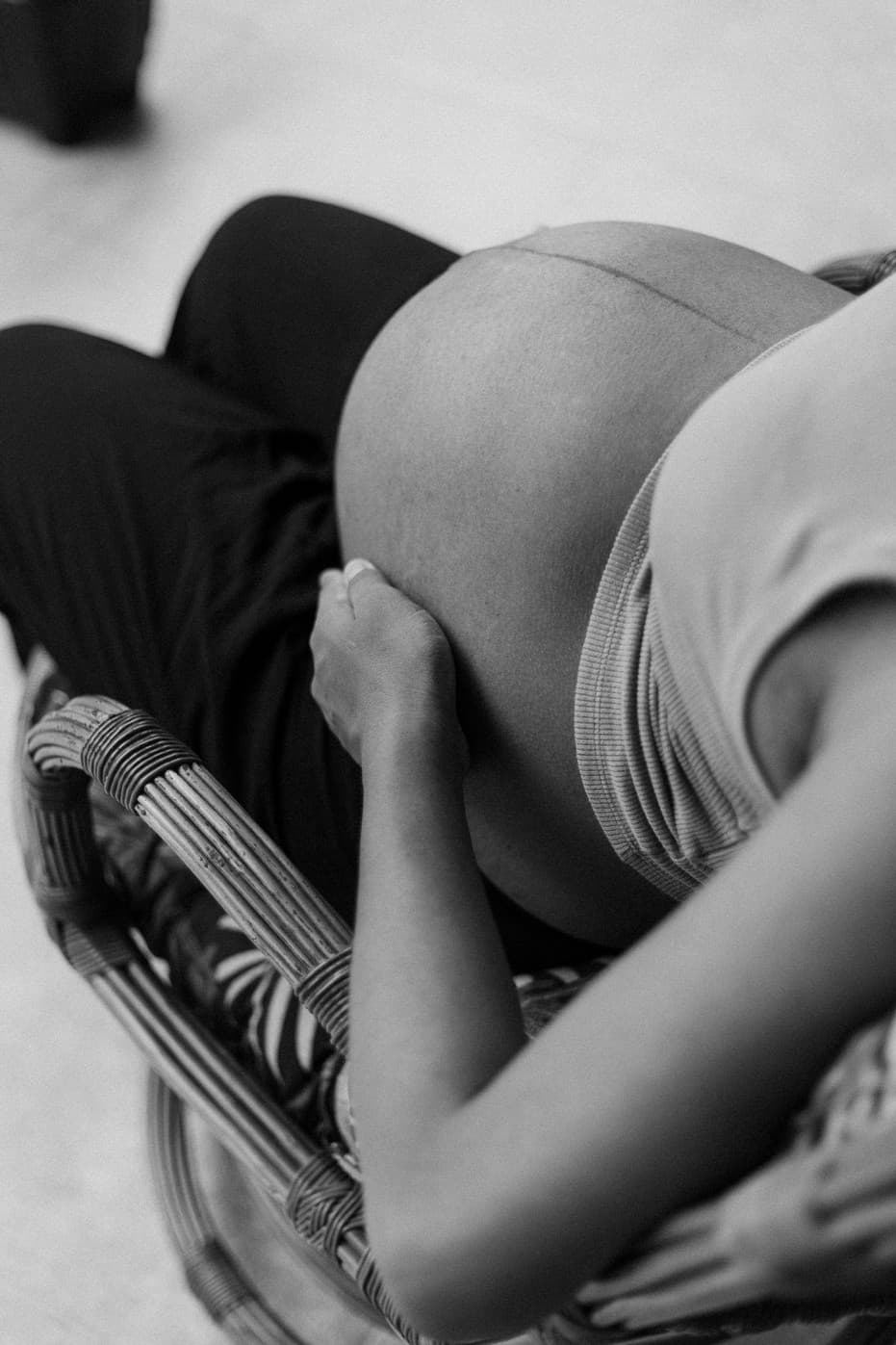 A pregnant parent seated in a calm setting